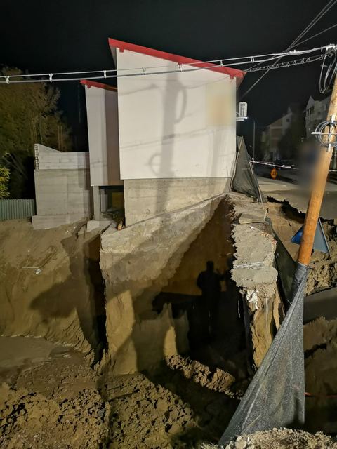 Clădirea pe marginea gropii de fundație de pe parcela vecină